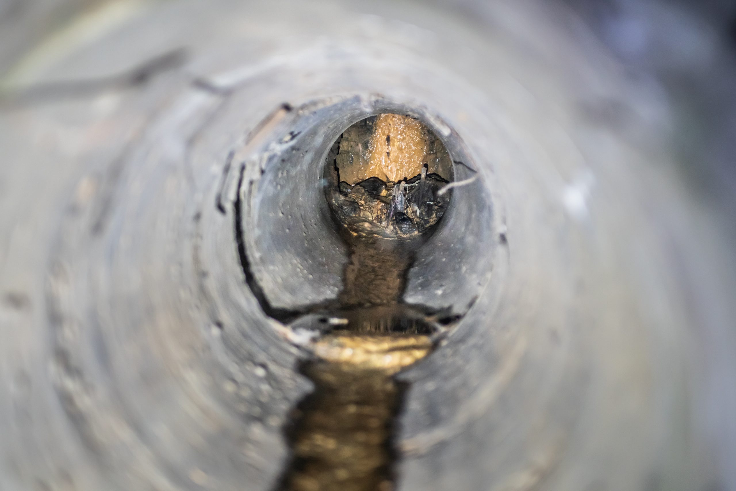 Inside a narrow concrete sewer pipe. Technik Rohrreinigung Diez